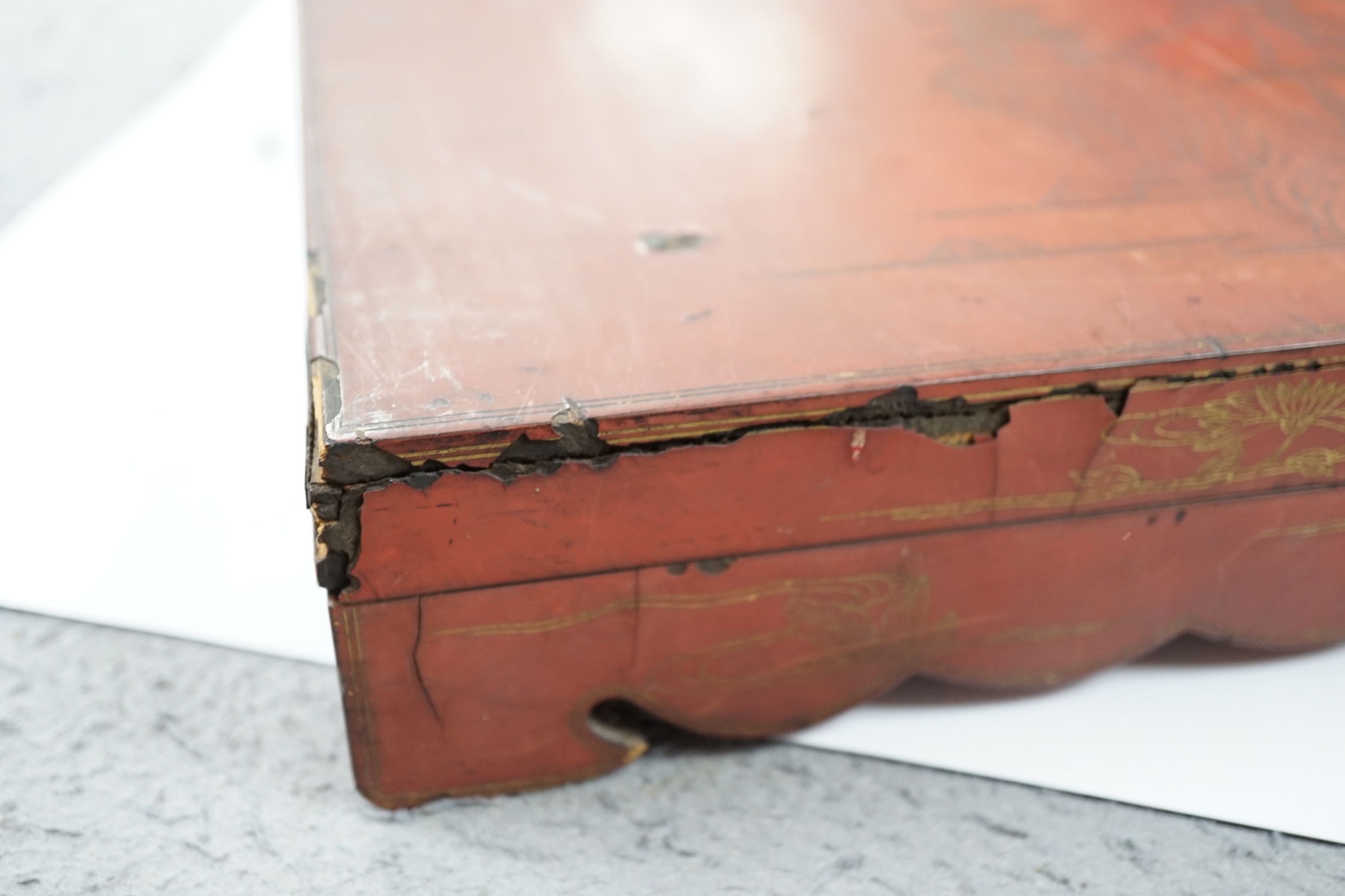 Literati interest: a Chinese red lacquer writing box, 26.5 x 24 x 6.5cm, with two inkstones, a brass paper cutter and ink cake. Condition - fair, some damage to edges and corners of the box